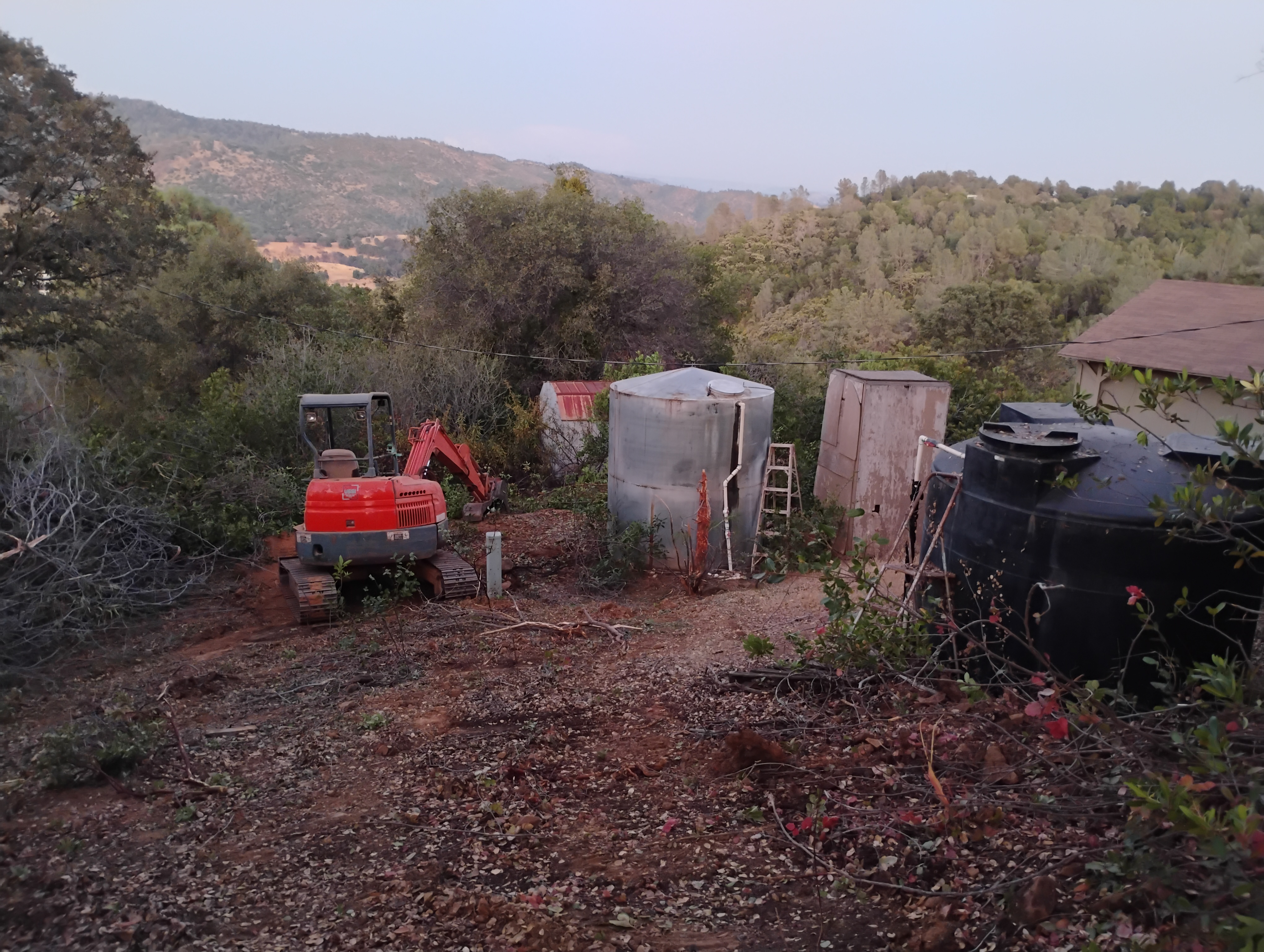 Defensible space clearing around water tank in Mariposa