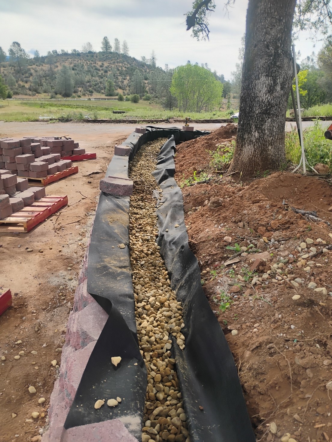Drainage installation and retaining wall base preparation in Mariposa CA